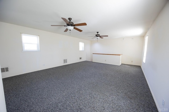 empty room with dark colored carpet and visible vents