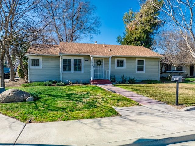 single story home with a front lawn