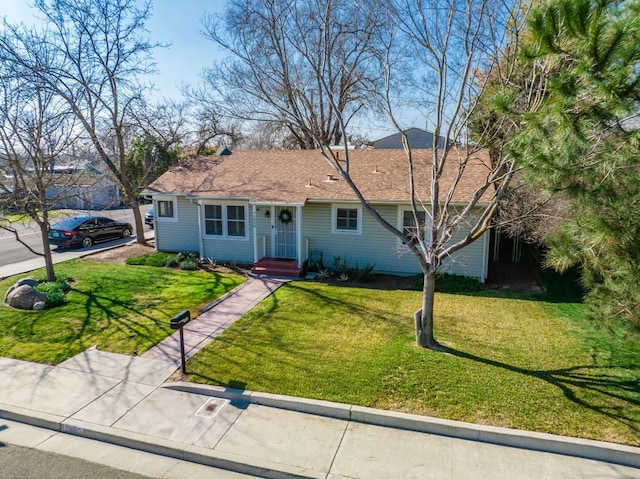 ranch-style home with a front lawn