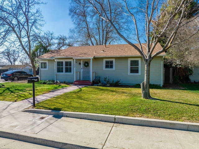 ranch-style house featuring a front lawn