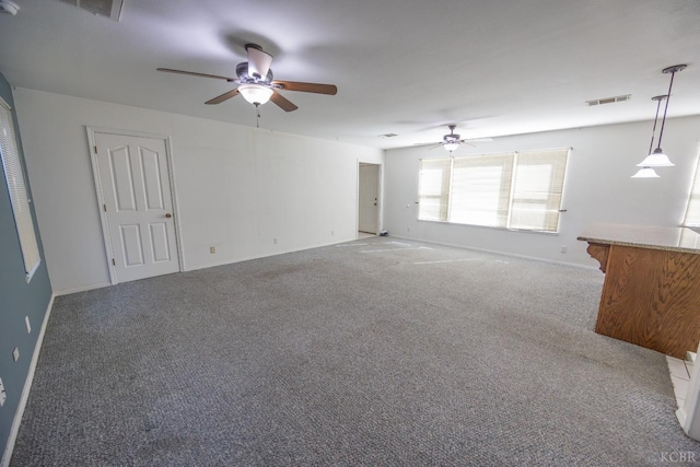 unfurnished living room featuring light carpet, baseboards, visible vents, and a ceiling fan