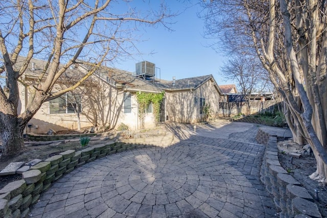 view of property exterior with central AC unit and a patio