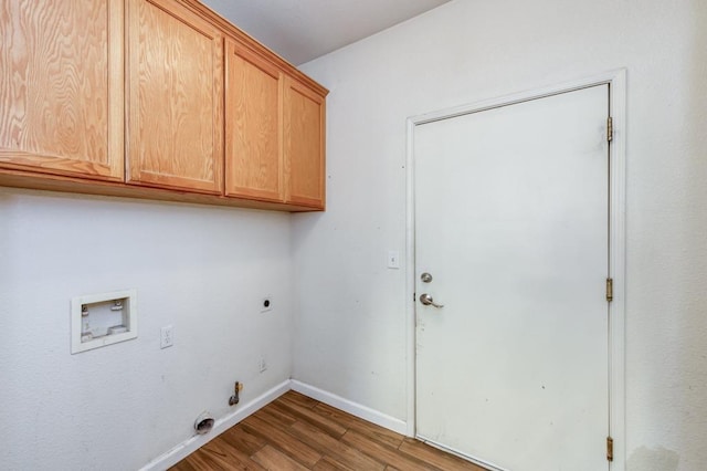 clothes washing area with hookup for an electric dryer, dark wood-type flooring, washer hookup, cabinets, and gas dryer hookup