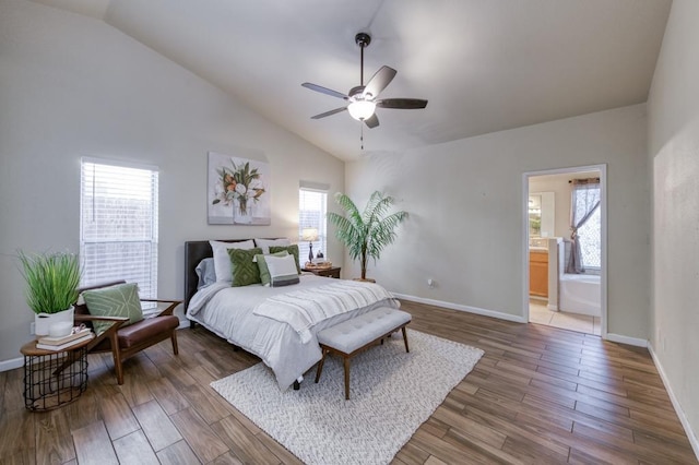 bedroom featuring ceiling fan, ensuite bathroom, and multiple windows