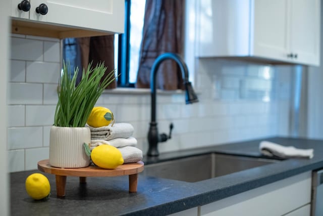 details featuring white cabinetry and sink