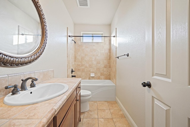 full bathroom with toilet, vanity, tiled shower / bath, and tile patterned flooring