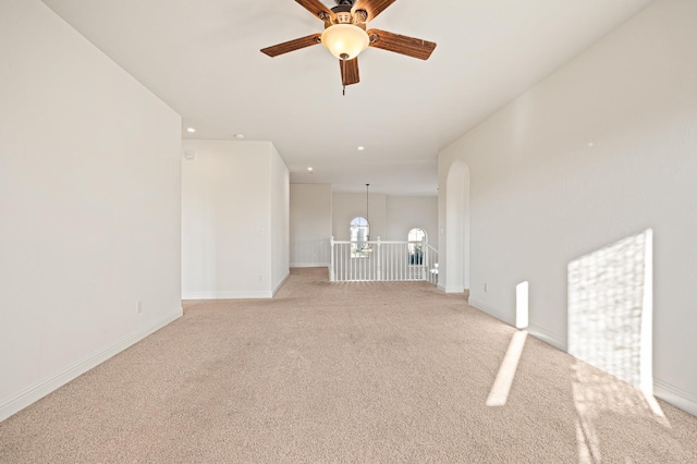 carpeted spare room featuring ceiling fan