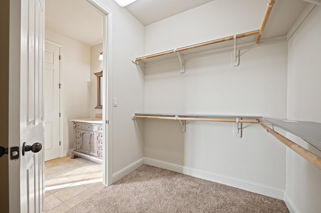 spacious closet featuring light colored carpet