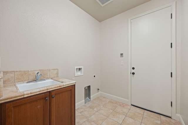 laundry area featuring sink, washer hookup, light tile patterned floors, hookup for an electric dryer, and cabinets