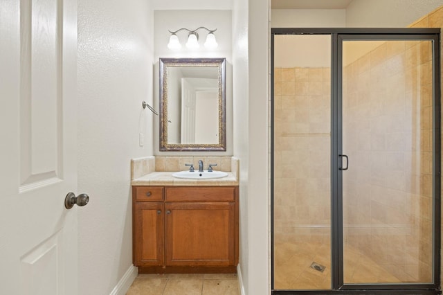 bathroom with vanity, tile patterned floors, and a shower with door