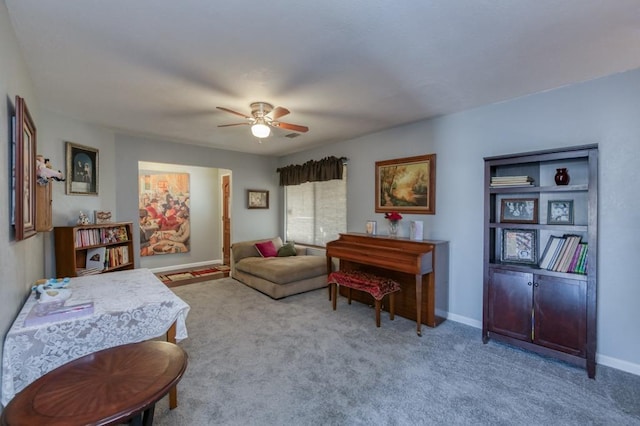 sitting room featuring light carpet and ceiling fan