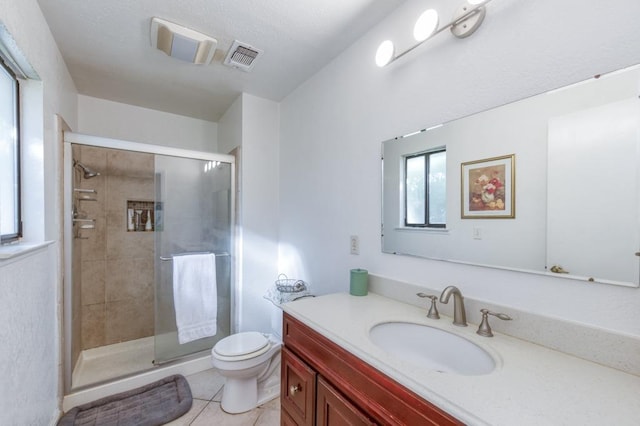 bathroom with toilet, vanity, walk in shower, and tile patterned flooring