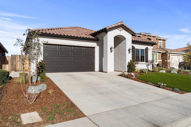 mediterranean / spanish house with a front yard, a garage, and solar panels