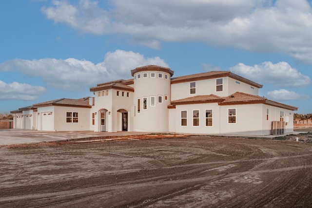 mediterranean / spanish house with a garage