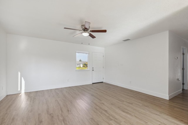 spare room with light wood-type flooring and ceiling fan