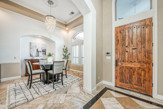 dining area with an inviting chandelier and ornamental molding