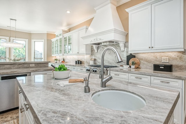 kitchen featuring stainless steel dishwasher, white cabinets, and custom range hood