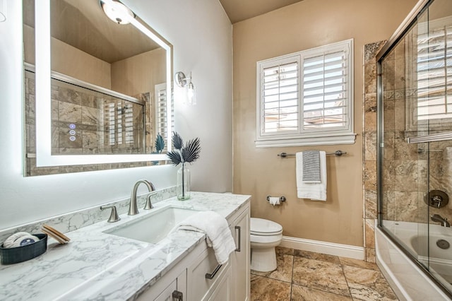 full bathroom featuring toilet, vanity, and shower / bath combination with glass door