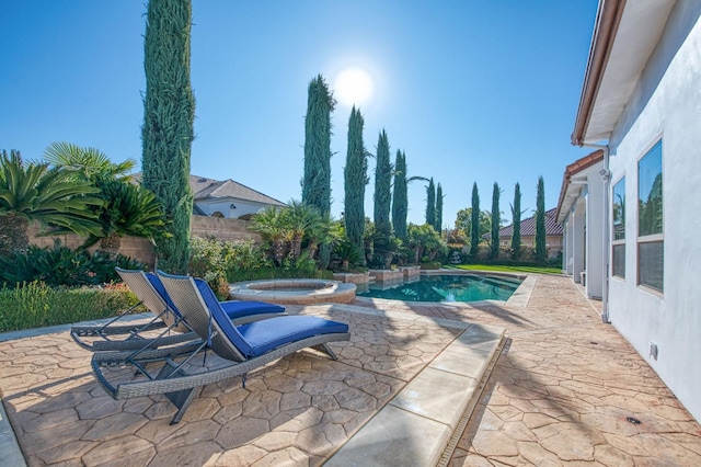 view of pool featuring an in ground hot tub and a patio