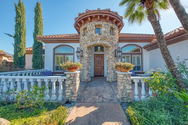 mediterranean / spanish house with a porch