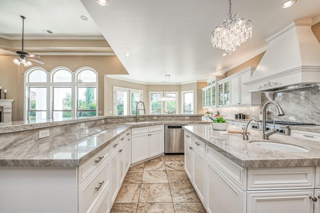 kitchen with custom exhaust hood, a spacious island, decorative light fixtures, dishwasher, and light stone countertops