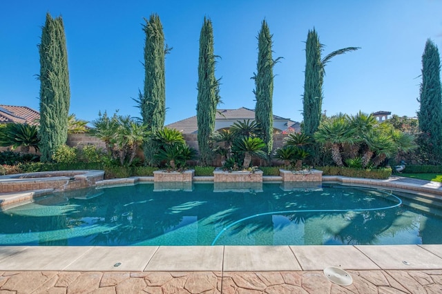 view of pool with an in ground hot tub