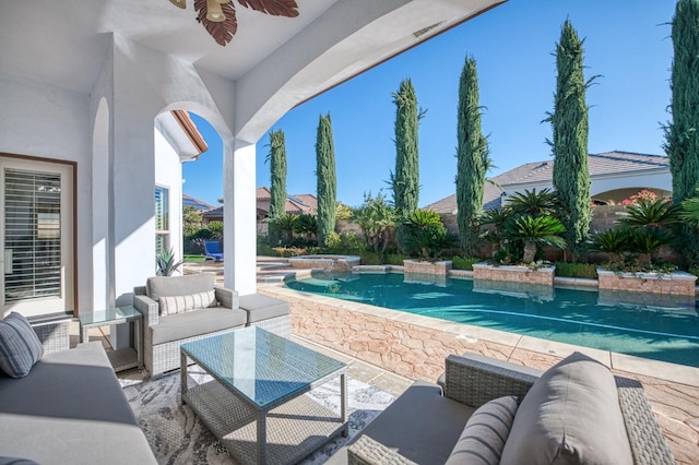 view of pool with ceiling fan, a patio area, and outdoor lounge area