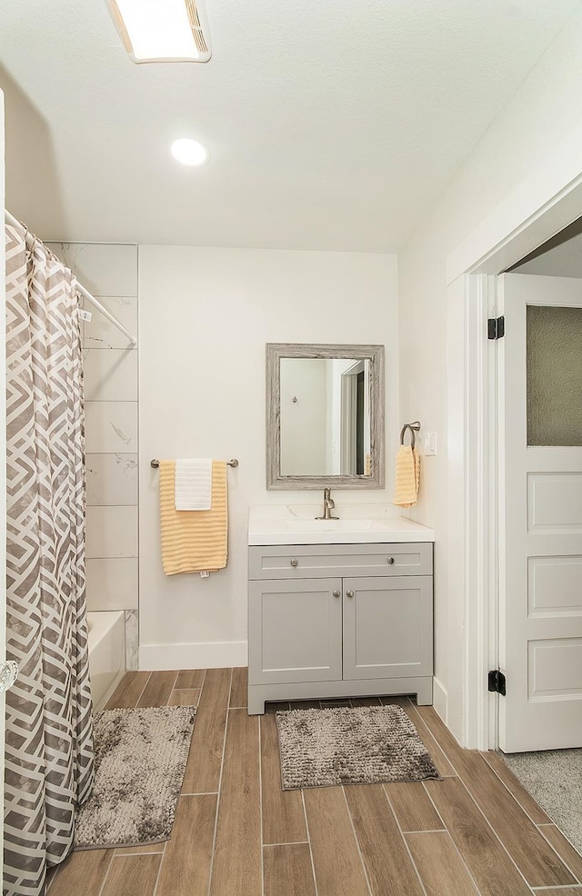 bathroom featuring vanity and shower / tub combo with curtain