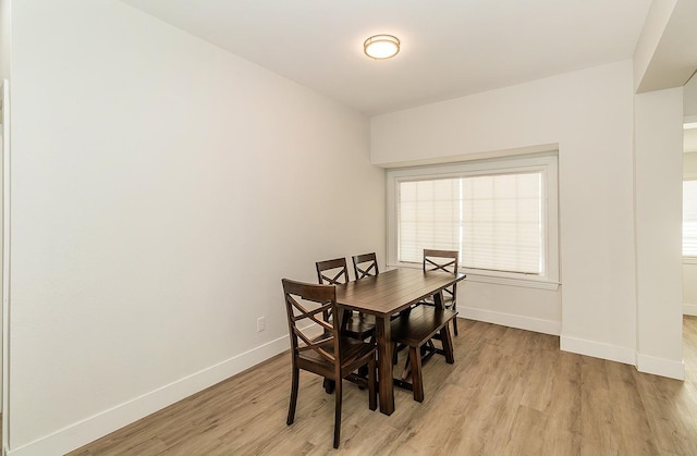 dining space with light wood-type flooring