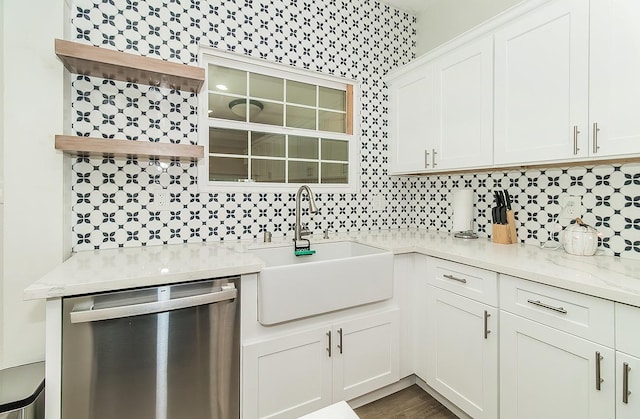 kitchen with dishwasher, white cabinetry, sink, backsplash, and light stone counters