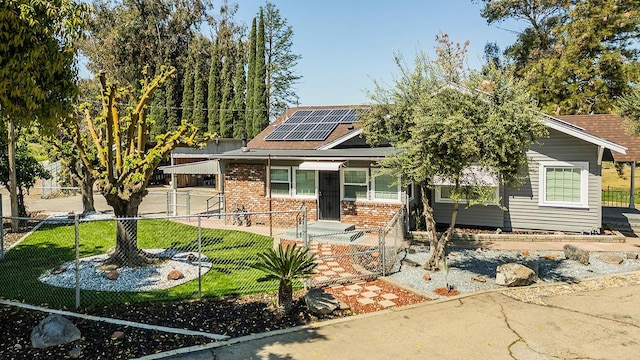 view of front of home with a front lawn and solar panels