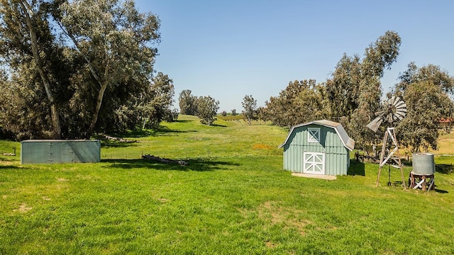 view of yard featuring a storage shed and a rural view