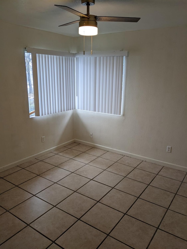 spare room featuring ceiling fan and light tile patterned floors