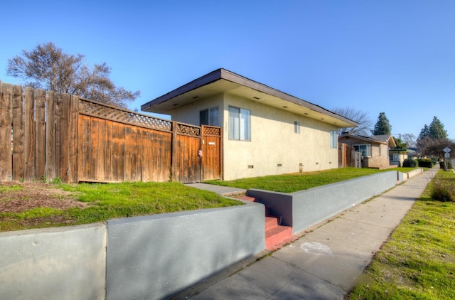 view of property exterior with a lawn