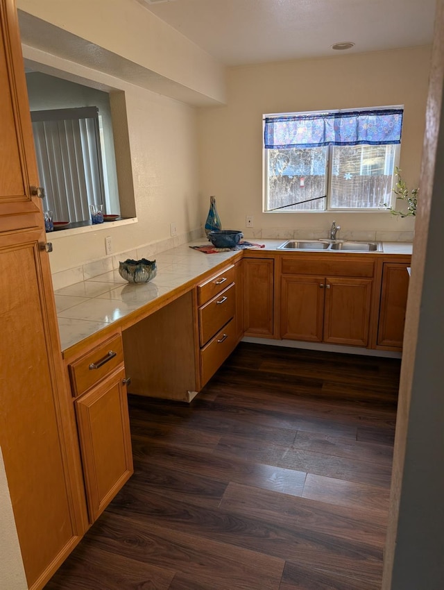 kitchen with sink, dark hardwood / wood-style floors, and tile countertops