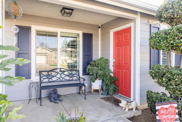 view of exterior entry featuring a porch