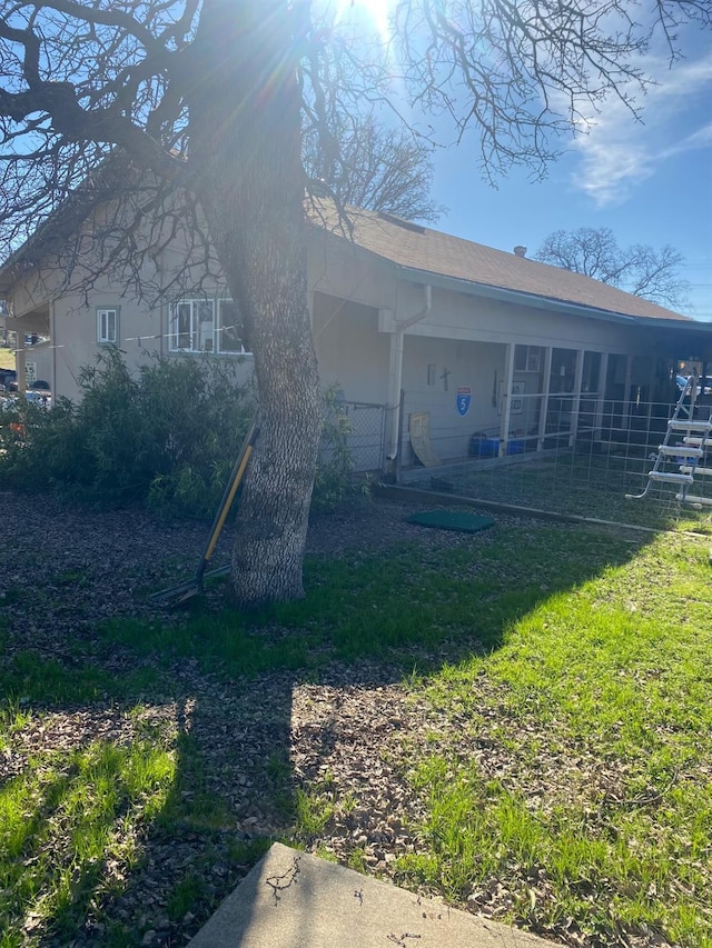 rear view of property featuring a yard