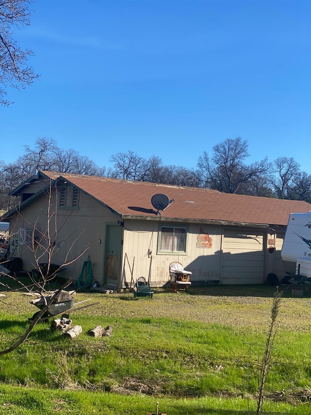 rear view of house featuring a yard