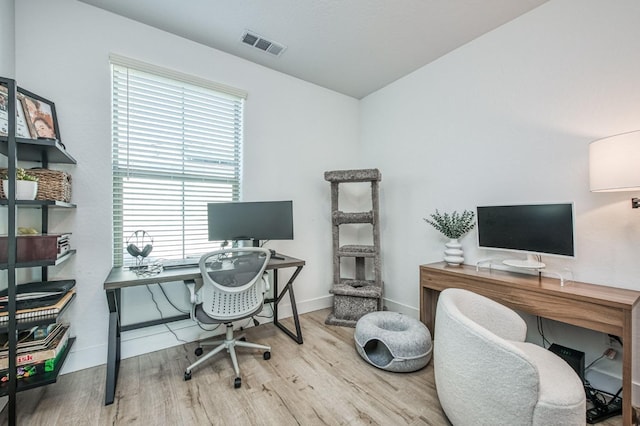 home office with visible vents, baseboards, and wood finished floors