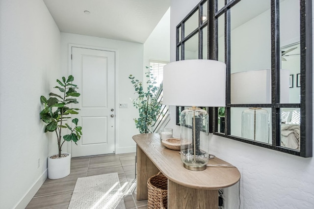 entryway with wood finished floors and baseboards