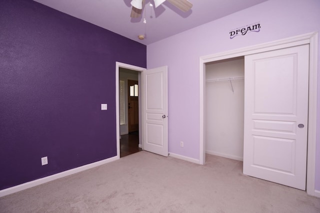 unfurnished bedroom featuring ceiling fan, light colored carpet, and a closet