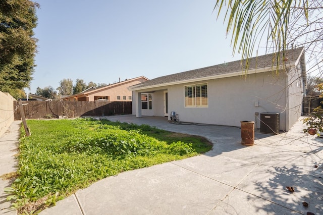 ranch-style home with a patio area and central AC unit