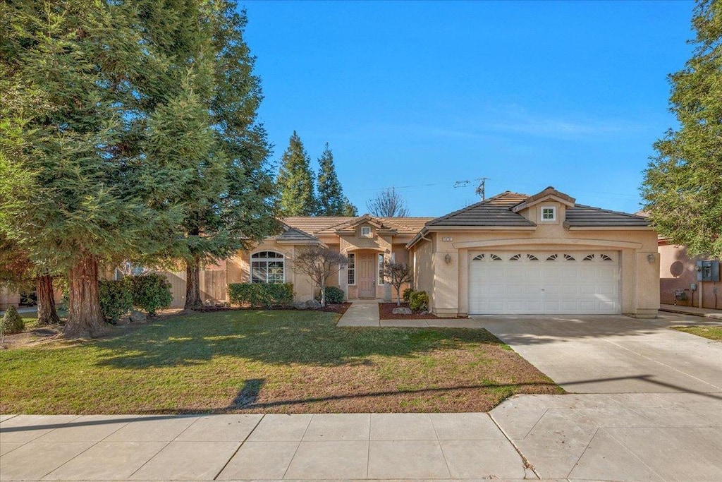 view of front of property with a front lawn and a garage