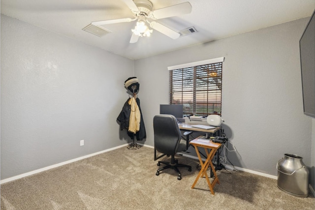 home office with ceiling fan and carpet