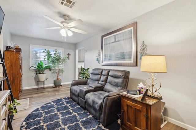 living room with hardwood / wood-style floors and ceiling fan