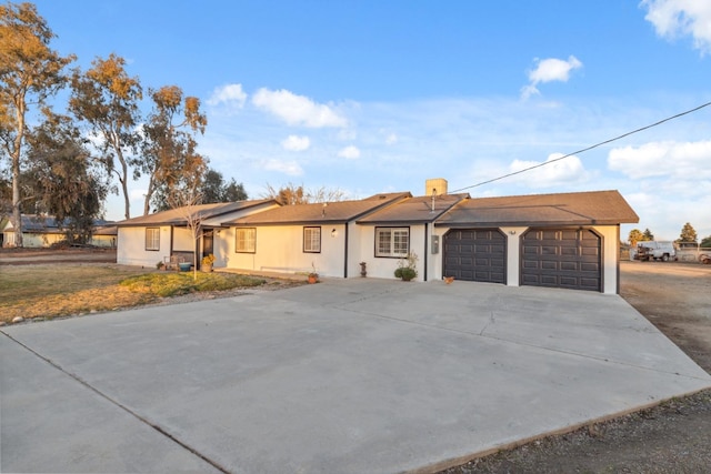 ranch-style home featuring a garage and a front lawn