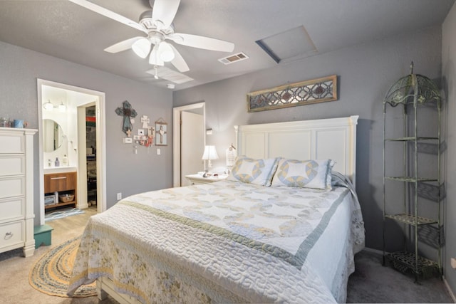 carpeted bedroom featuring connected bathroom and ceiling fan