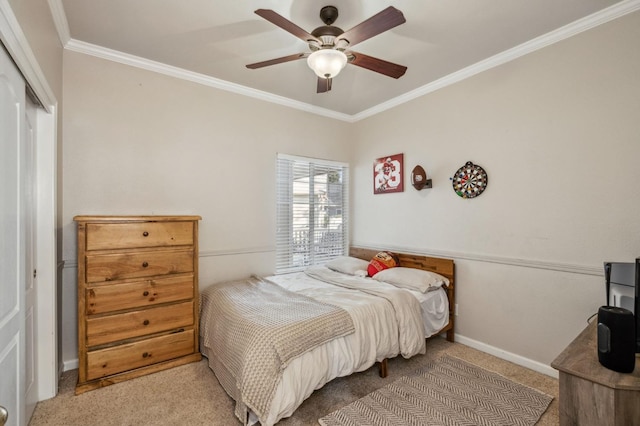 bedroom with ceiling fan, carpet, a closet, and crown molding