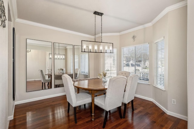 dining area with dark wood-type flooring, ornamental molding, and an inviting chandelier