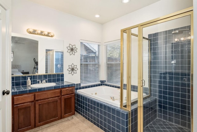 bathroom with vanity, tile patterned floors, and plus walk in shower